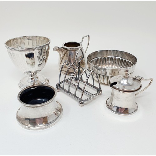 286 - A silver bowl, a cream jug, a sugar bowl, a four section toast rack, a mustard pot, and a salt, vari... 