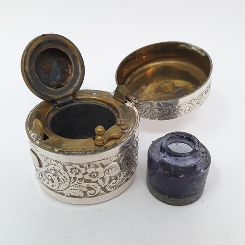 332 - A silver cased travelling inkwell, with embossed floral decoration, 4.5 cm diameter