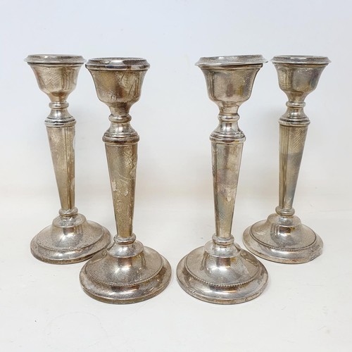 335 - A set of George V silver candlesticks, Birmingham 1914, 15 cm high, bases filled (4)