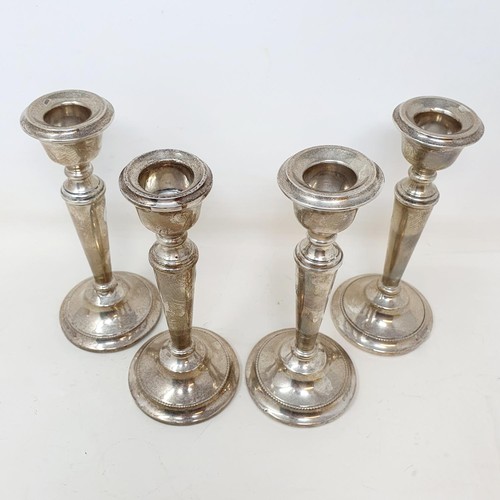 335 - A set of George V silver candlesticks, Birmingham 1914, 15 cm high, bases filled (4)