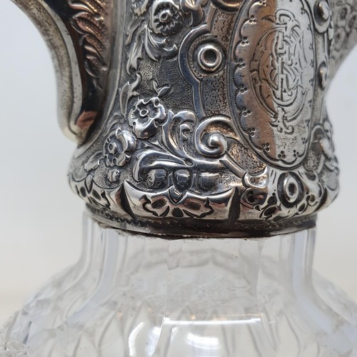 340 - A Victorian cut glass claret jug, with a silver mount