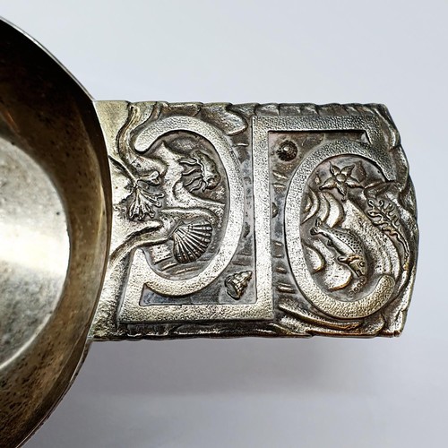 342 - A modern silver wine taster, the handle decorated a fish, shell and flower, inscribed and dated to t... 