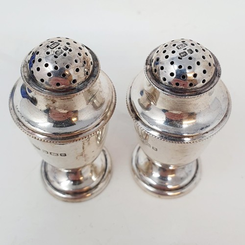 356 - A pair of Edward VII silver pepperpots, Sheffield 1910, cased