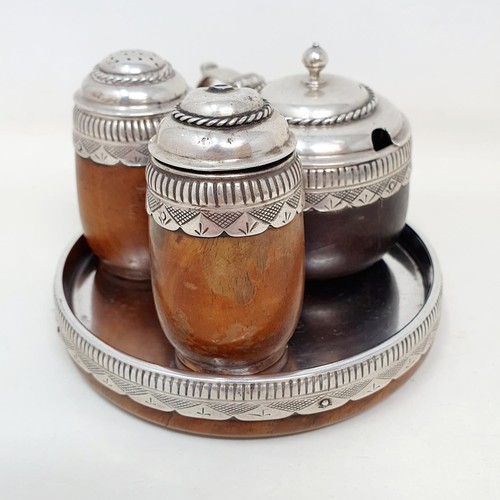 367 - An Arts & Crafts silver and turned wood three piece cruet and stand, London 1938 (4)