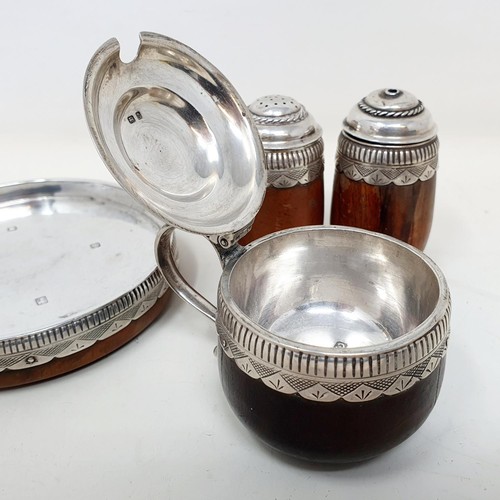 367 - An Arts & Crafts silver and turned wood three piece cruet and stand, London 1938 (4)