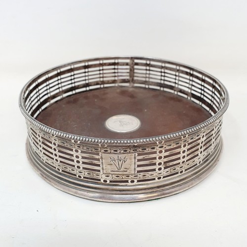 369 - A George III silver and mahogany bottle coaster, marks rubbed, 14 cm diameter