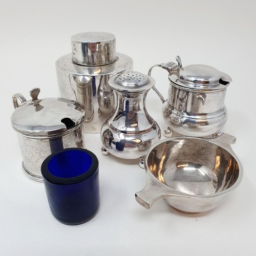 334 - A silver caddy, two mustard pots, a pepperpot, and a salt in the form of a quaiche, various dates an... 