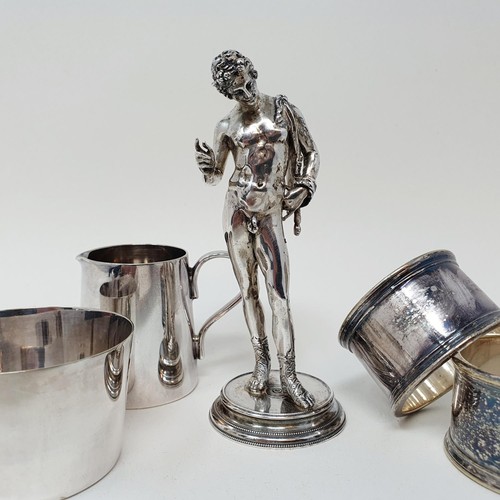 360 - A silver coloured metal figure of a man in classical pose, a salt, a jug, two napkin rings, and four... 