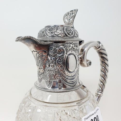 300 - A Victorian cut glass claret jug, with a silver mount and handle, Sheffield 1890, 28 cm high