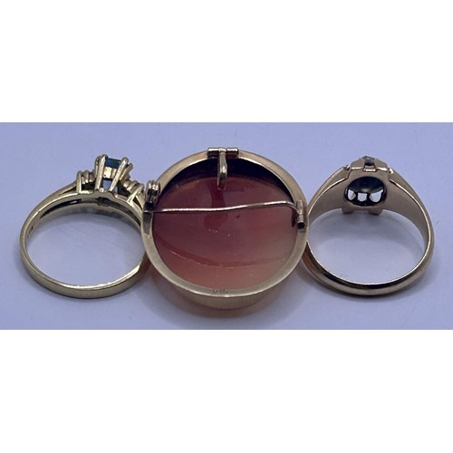 83 - A 9ct gold and aquamarine ring, a yellow metal and white stone ring, and a cameo brooch (3)