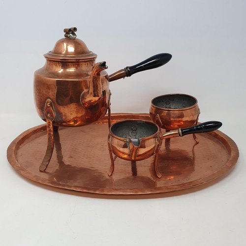 516 - A Scandinavian copper tea set, comprising a kettle, milk jug, sugar bowl and an oval tray, 45 cm wid... 