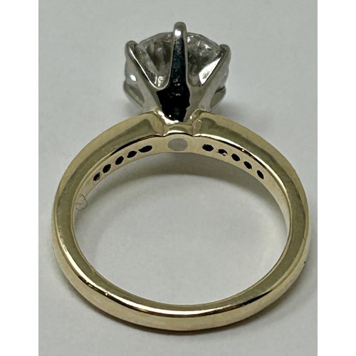 100 - A diamond solitaire ring, approx. 2.5ct, with a yellow coloured metal band,  set diamond shoulders, ... 