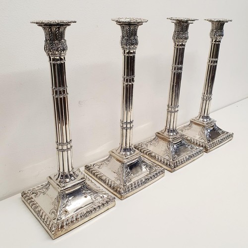 259 - A set of four George III silver candlesticks, in the form of cluster columns on a square base, with ... 