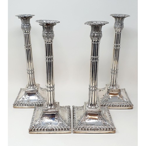 259 - A set of four George III silver candlesticks, in the form of cluster columns on a square base, with ... 