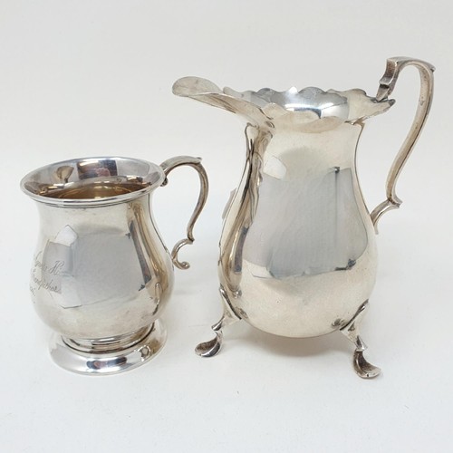 294 - A silver cream jug, Chester 1910, and a silver mug, 7.6 ozt (2)