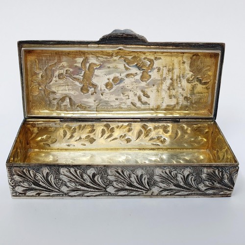 312 - A Spanish sliver box, in the ditch style decorated cherubs, 74.7 g, 8 cm wide