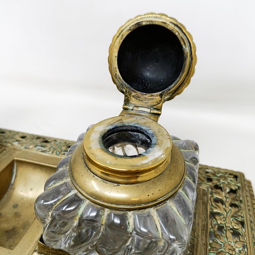 504 - An early 20th century brass inkstand, with a pair of glass inkwells, 36 cm wide