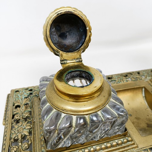 504 - An early 20th century brass inkstand, with a pair of glass inkwells, 36 cm wide