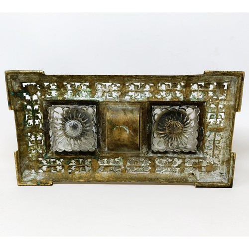 504 - An early 20th century brass inkstand, with a pair of glass inkwells, 36 cm wide