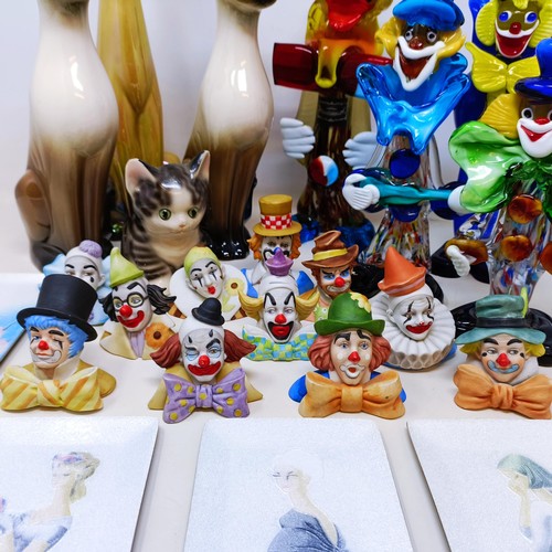 523 - A Murano glass clown, 30 cm high, two others, a pair of pottery cats, another, assorted clown figure... 