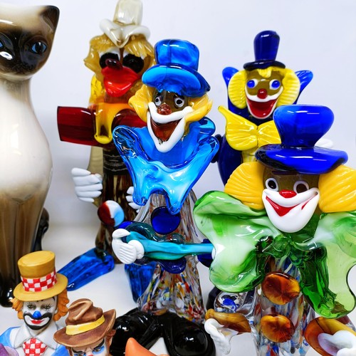 523 - A Murano glass clown, 30 cm high, two others, a pair of pottery cats, another, assorted clown figure... 