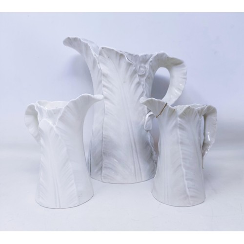 530 - A Royal Worcester set of four graduated leaf molded jugs, the largest 24 cm high, and two similar su... 