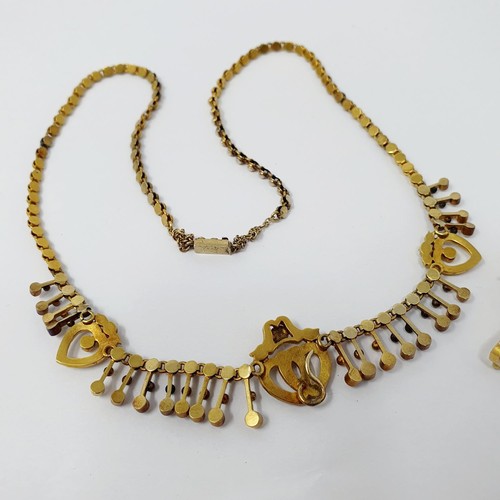 202 - A late 19th century yellow metal and seed pearl necklace, having a double heart motif, with a matchi... 