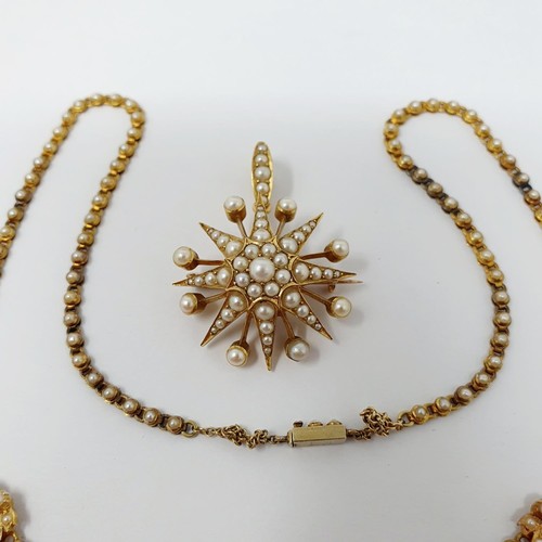 202 - A late 19th century yellow metal and seed pearl necklace, having a double heart motif, with a matchi... 