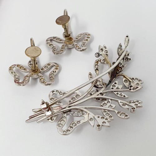 189 - ***Withdrawn*** An early 20th century white coloured metal and diamond bow and floral brooch, and a ... 