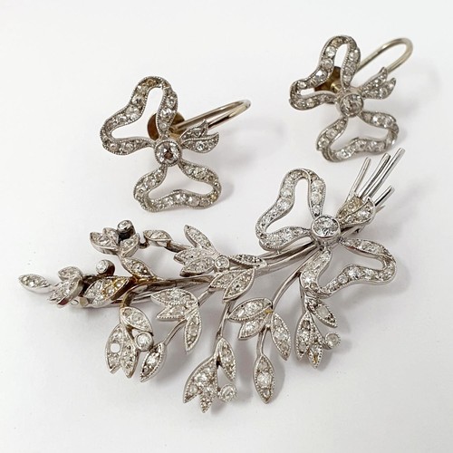 189 - ***Withdrawn*** An early 20th century white coloured metal and diamond bow and floral brooch, and a ... 