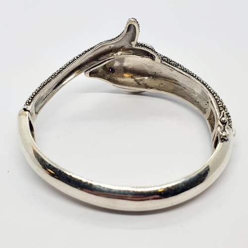 220A - A silver and marcasite dolphin form bangle