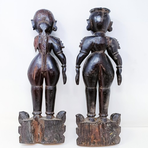 521 - A pair of carved wood Eastern figures, 40 cm high (2)