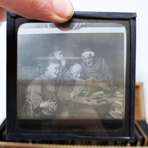 559 - Assorted magic lantern slides, boxed, and a sword stick (2)