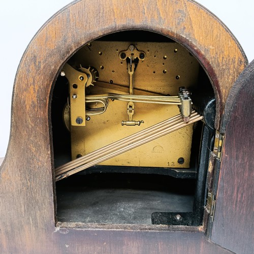 561 - A mantel clock, in a mahogany case, 34 cm high, and another (2)