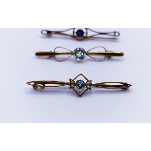 141 - An aquamarine and seed pearl bar brooch and two other bar brooches (3)