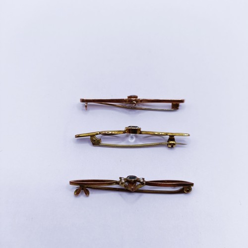 141 - An aquamarine and seed pearl bar brooch and two other bar brooches (3)