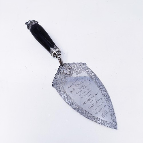 419 - A silver coloured metal ceremonial trowel with an ebonised handle, the finial in the form of a beave... 