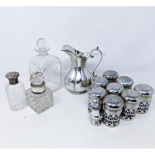 421 - A silver pepperette, a silver mounted bottle, a set of eight silver plated pepper pots with blue gla... 