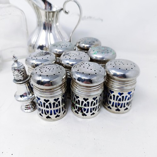 421 - A silver pepperette, a silver mounted bottle, a set of eight silver plated pepper pots with blue gla... 