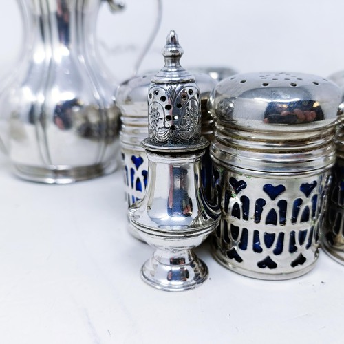 421 - A silver pepperette, a silver mounted bottle, a set of eight silver plated pepper pots with blue gla... 