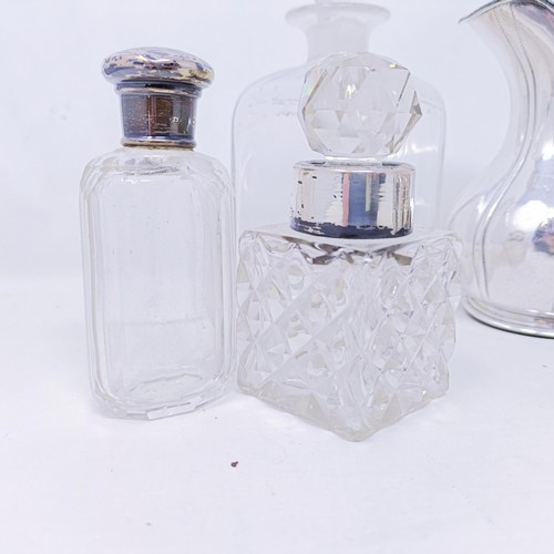 421 - A silver pepperette, a silver mounted bottle, a set of eight silver plated pepper pots with blue gla... 