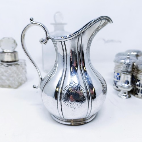 421 - A silver pepperette, a silver mounted bottle, a set of eight silver plated pepper pots with blue gla... 