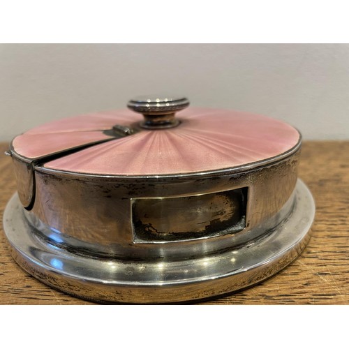 424 - A George V silver and pink enamel match strike, 13 cm diameter, provenance reportedly from the Lonsd...