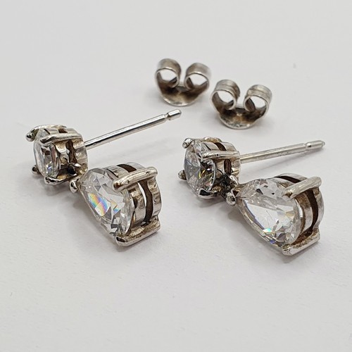 5 - A pair of diamond drop earrings, with round and pear shaped stones...