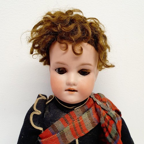 67 - An Armand Marseille bisque headed Scottish Boy doll, No 390, with a jointed composite body, millefio... 