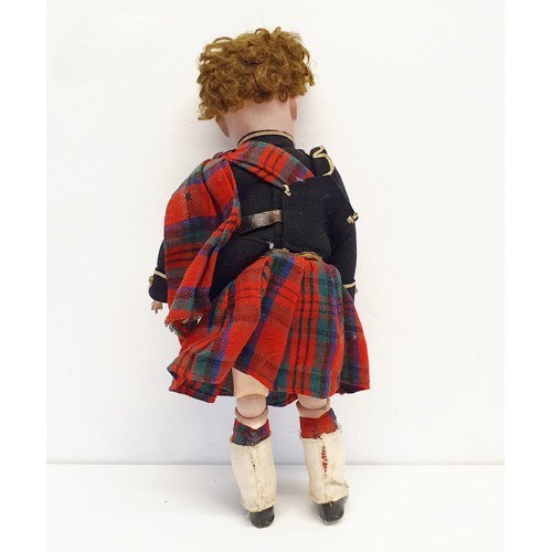 67 - An Armand Marseille bisque headed Scottish Boy doll, No 390, with a jointed composite body, millefio... 