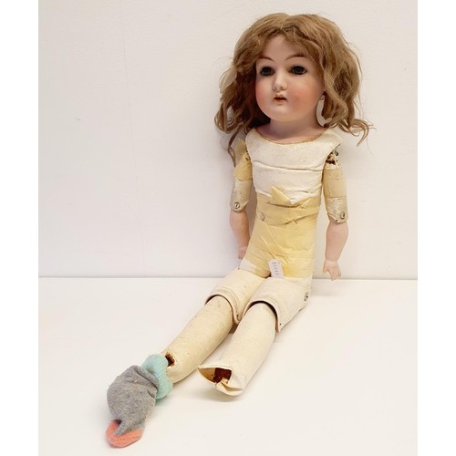 68 - A German bisque headed doll, makers mark H, with a jointed composite and leather body, and millefior... 