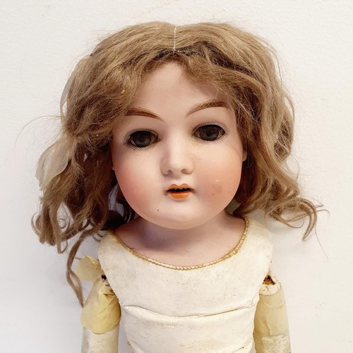 68 - A German bisque headed doll, makers mark H, with a jointed composite and leather body, and millefior... 