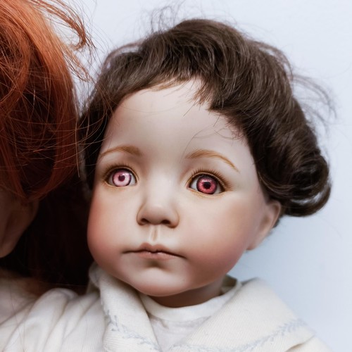 63 - An Armand Marseille German bisque head doll, with composite body and millefiori glass eyes, lacking ... 