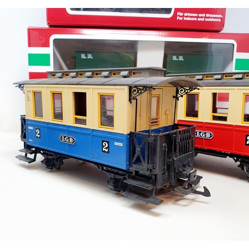 56 - A Lehmann Gross Bahn (LGB) G scale 0-4-0 locomotive, two carriages, and related items (2 boxes)